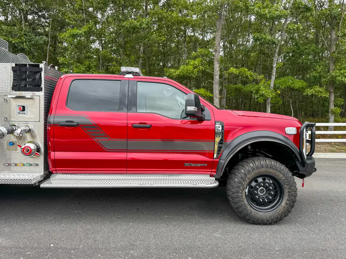 Battery tray compartment close-up with mounted battery and bracket.